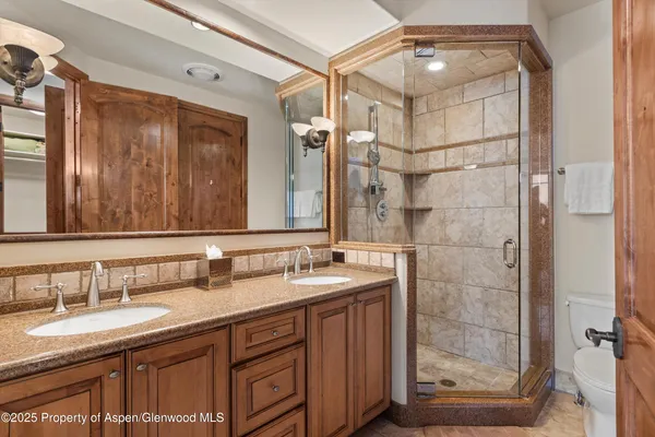 a bathroom with a granite countertop sink mirror and double