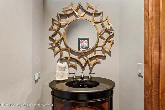 a vase of flowers sitting on a table and a mirror