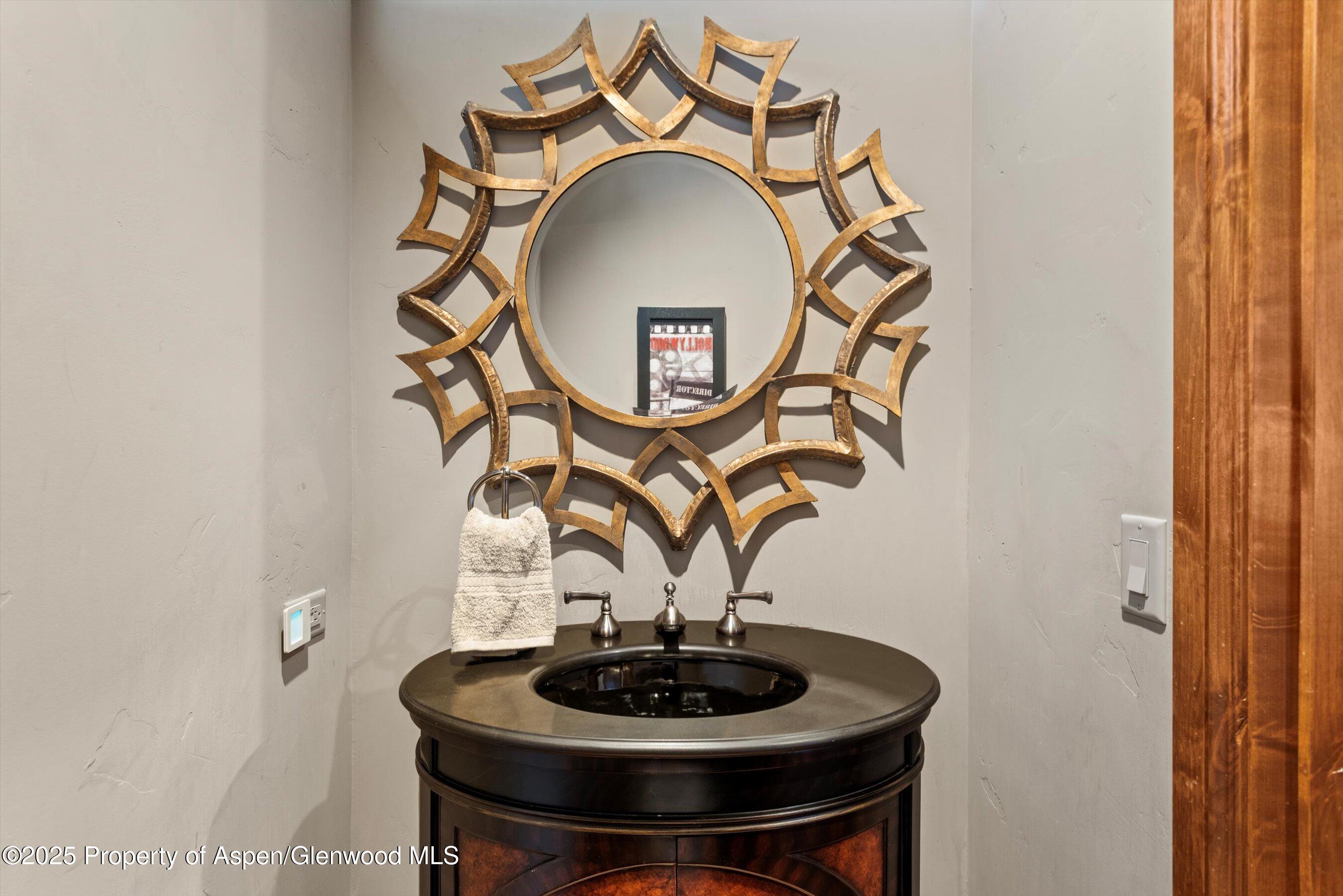 121 Oak Ridge Road Snowmass Village, CO 81615 - Photo 28 of 28 a vase of flowers sitting on a table and a mirror