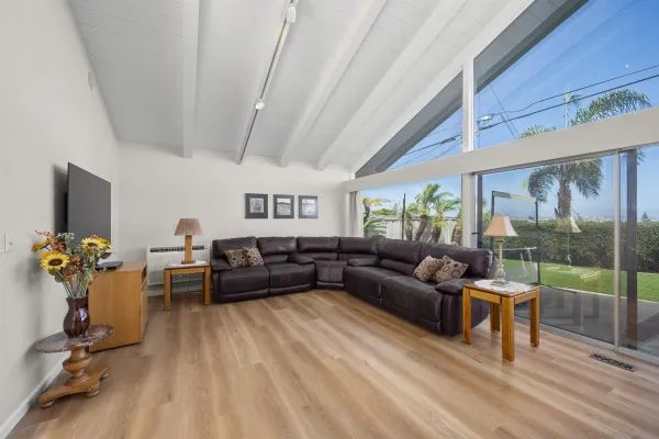 a living room with furniture and a floor to ceiling window