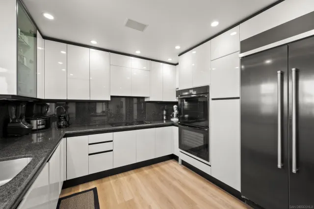 a kitchen with a sink stainless steel appliances and cabinets