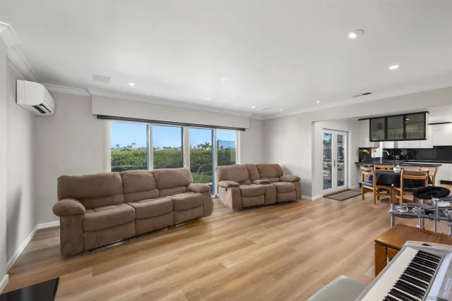 a bedroom with a bed and a flat tv screen on wall