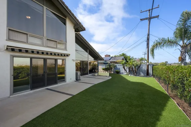 a backyard of a house with table and chairs