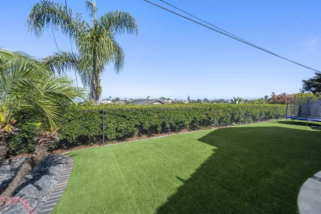 a view of a house with backyard and plants