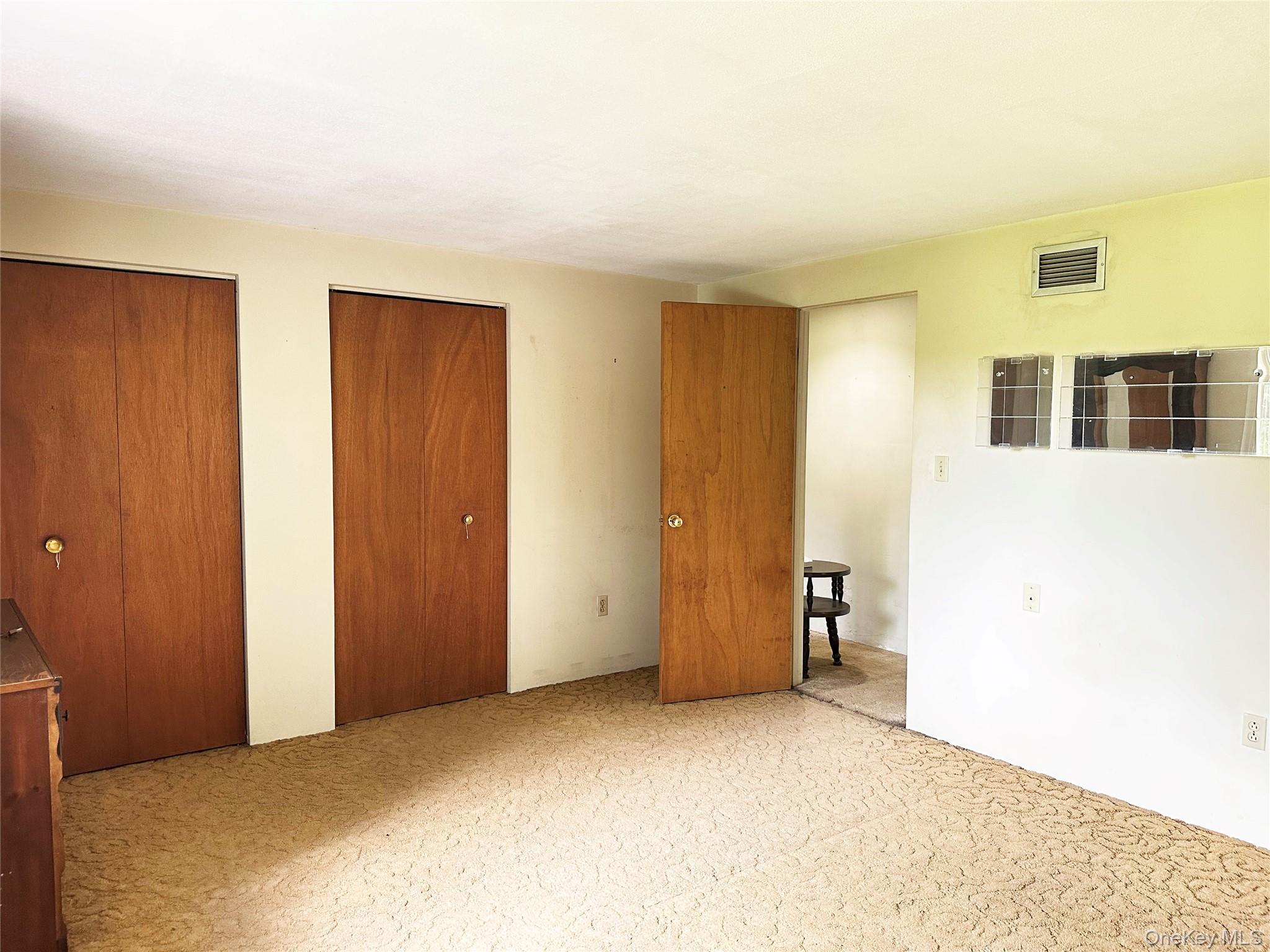818 Methol Road Roscoe, NY 12776 - Photo 29 of 39 Spacious bedroom with dual closets, large windows, and peaceful views of the surrounding property.