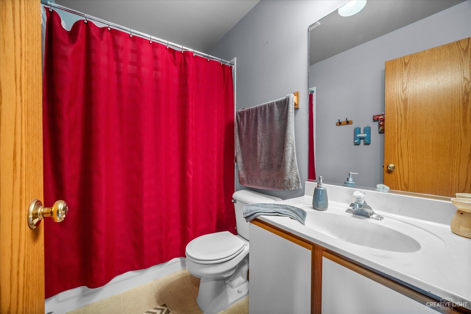 1813 Olde Mill Road Plainfield, IL 60586 - Photo 22 of 34 a bathroom with a sink a toilet and shower curtain