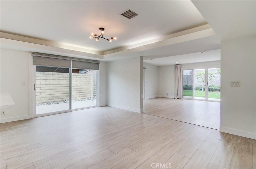 4541 Myra Avenue Cypress, CA 90630 - Photo 11 of 42 a view of an empty room with wooden floor and a window