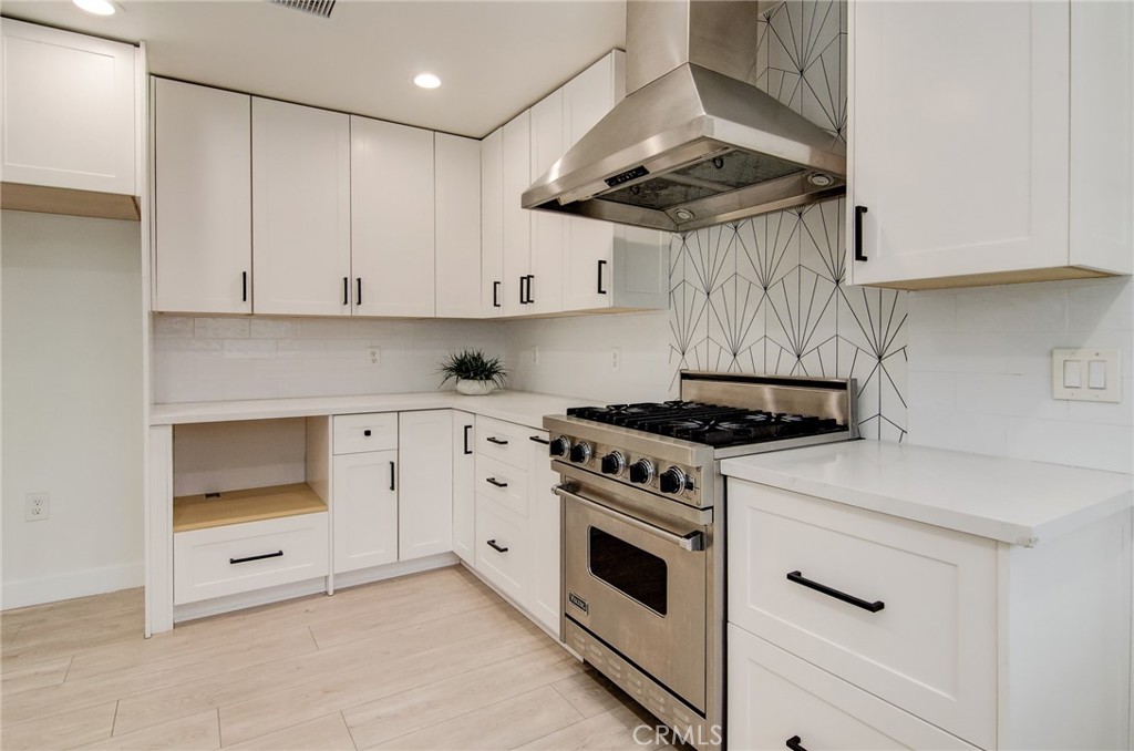 4541 Myra Avenue Cypress, CA 90630 - Photo 16 of 42 a kitchen with white cabinets and white appliances