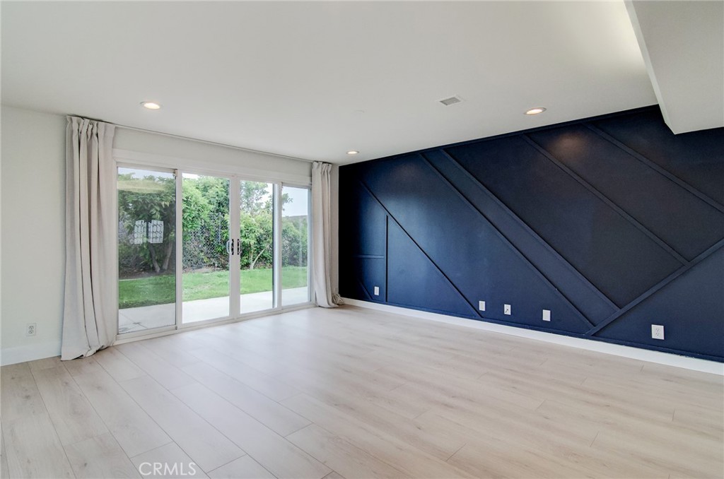 4541 Myra Avenue Cypress, CA 90630 - Photo 20 of 42 a view of an empty room with wooden floor and a window