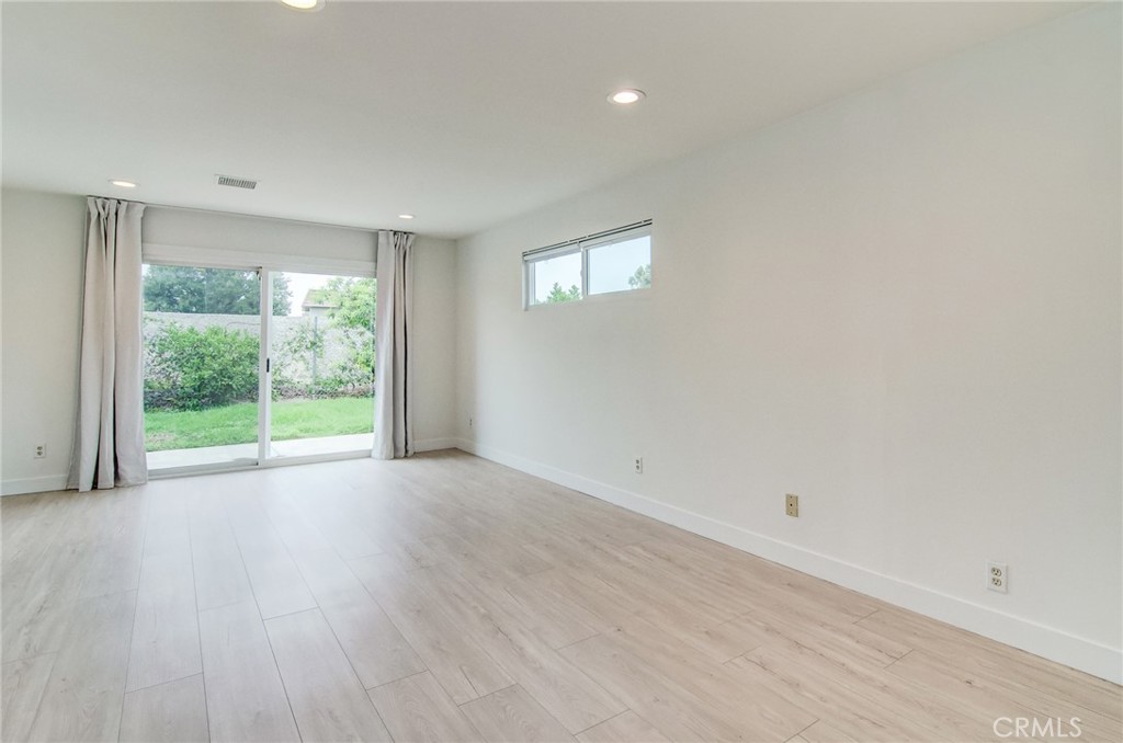 4541 Myra Avenue Cypress, CA 90630 - Photo 28 of 42 a view of an empty room with wooden floor and a window