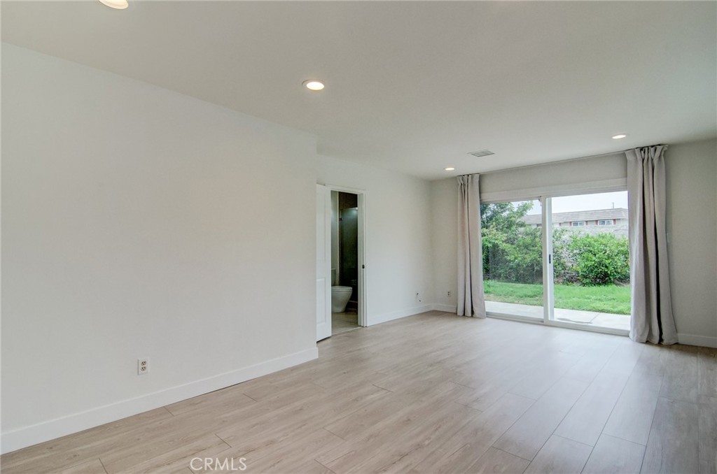 4541 Myra Avenue Cypress, CA 90630 - Photo 29 of 42 a view of a room with wooden floor and white walls