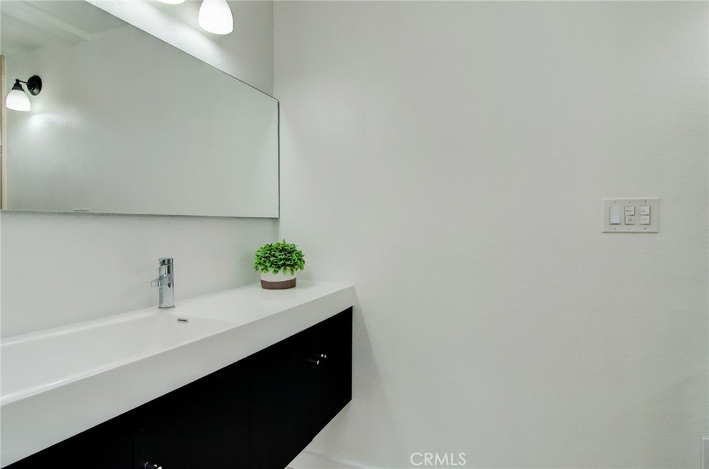 4541 Myra Avenue Cypress, CA 90630 - Photo 32 of 42 a bathroom with a sink and a mirror