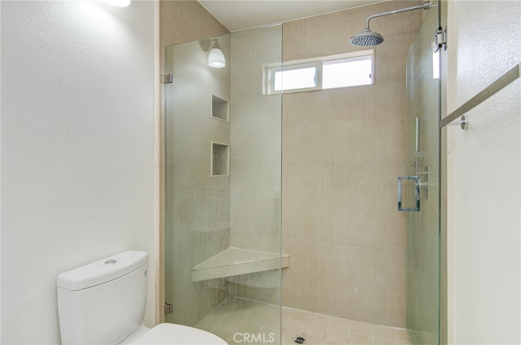 4541 Myra Avenue Cypress, CA 90630 - Photo 33 of 42 a bathroom with a shower and a toilet