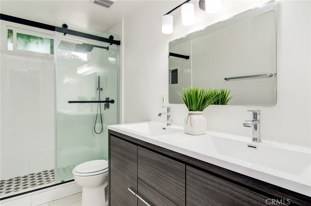 4541 Myra Avenue Cypress, CA 90630 - Photo 35 of 42 a bathroom with a sink a toilet and shower