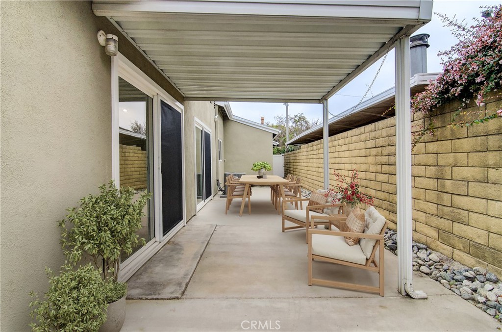 4541 Myra Avenue Cypress, CA 90630 - Photo 9 of 42 a patio with table and chairs and potted plants
