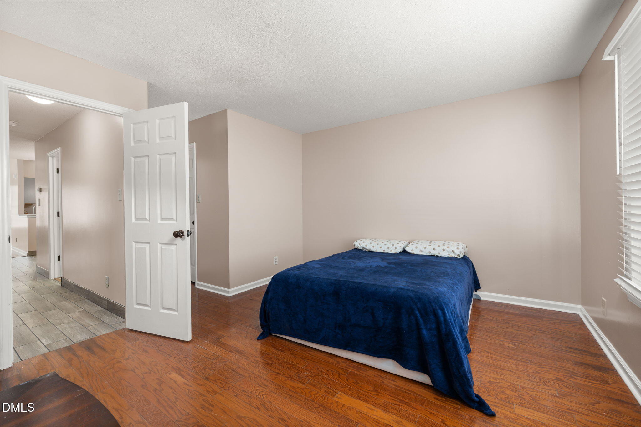 505 Stratton Way Durham, NC 27704 - Photo 15 of 34 a bedroom with a bed and wooden floor