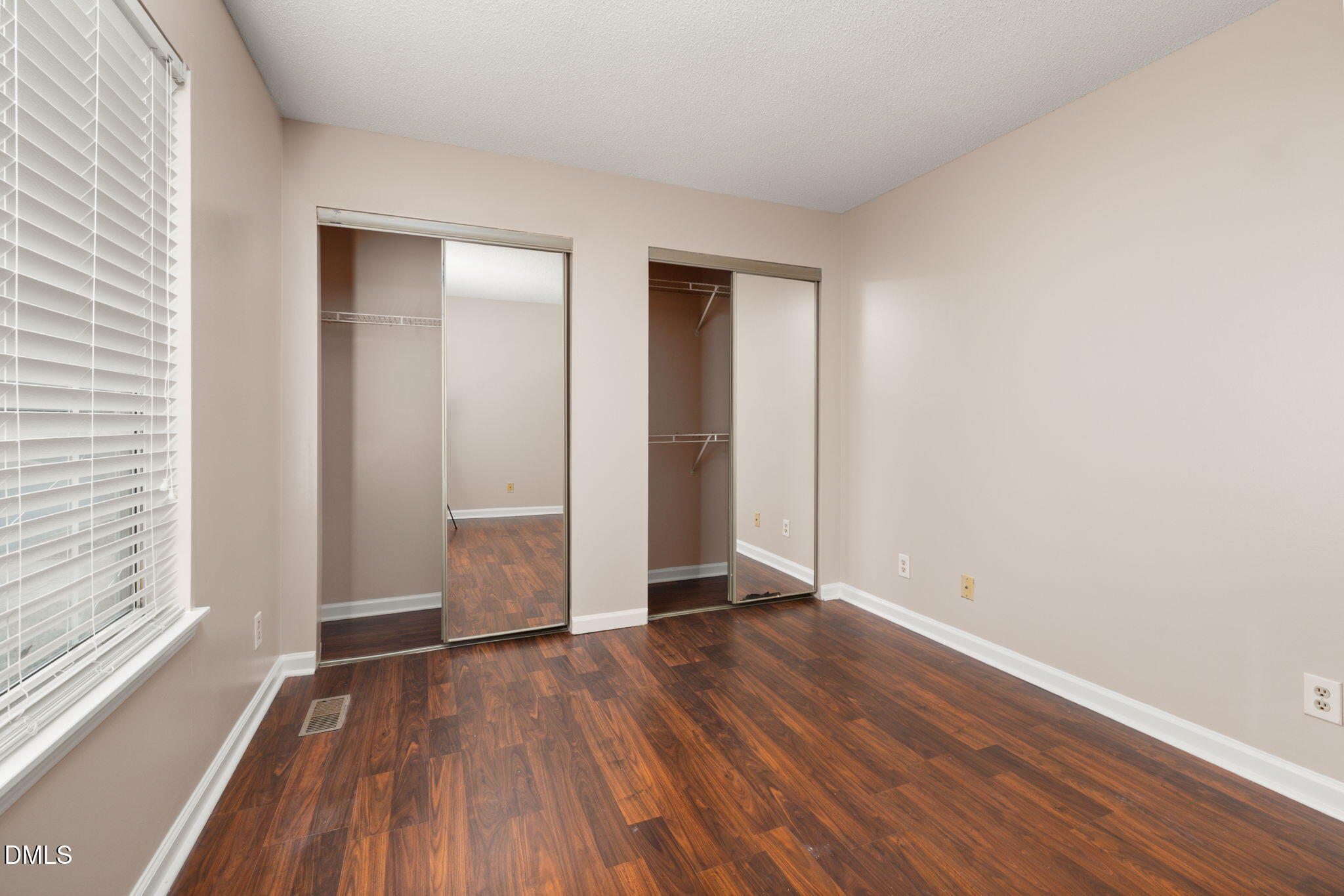 505 Stratton Way Durham, NC 27704 - Photo 16 of 34 an empty room with wooden floor and windows