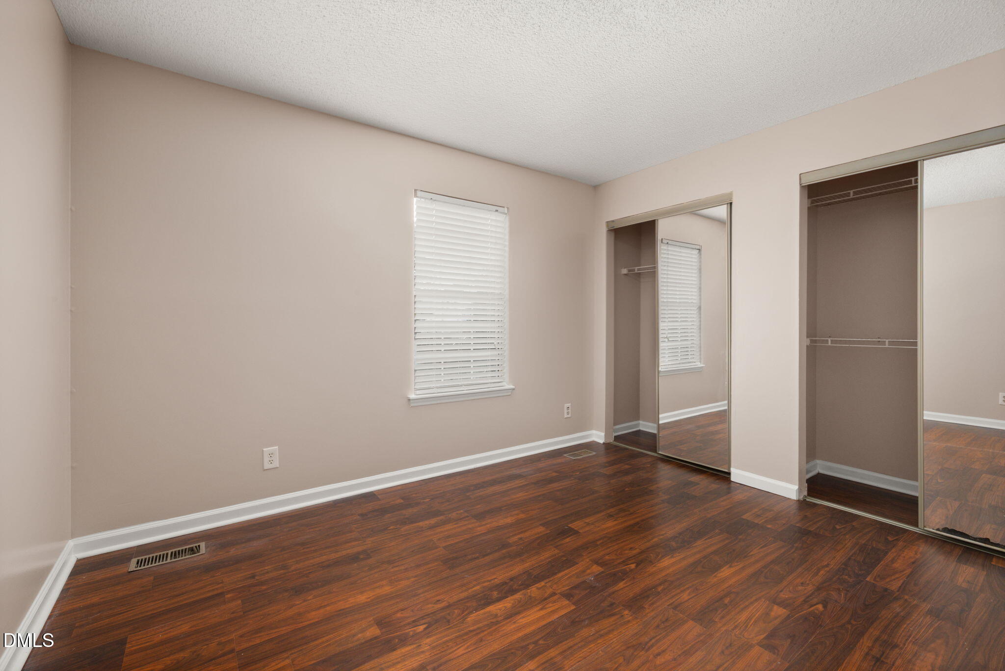 505 Stratton Way Durham, NC 27704 - Photo 18 of 34 an empty room with wooden floor and windows