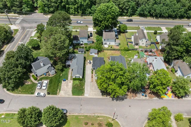 an aerial view of a house with a yard swimming pool outdoor seating and yard