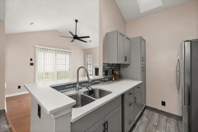 a kitchen with stainless steel appliances a sink a stove and a refrigerator