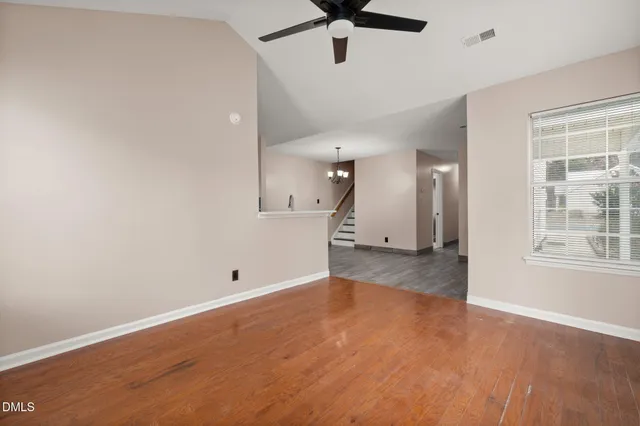 wooden floor in an empty room with a window