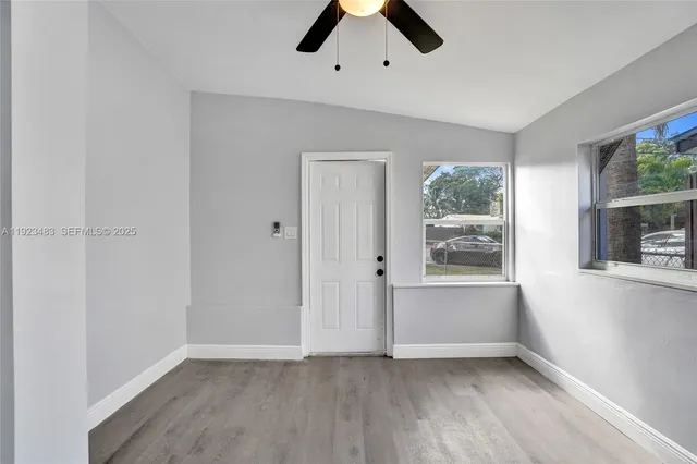 an empty room with windows and closet