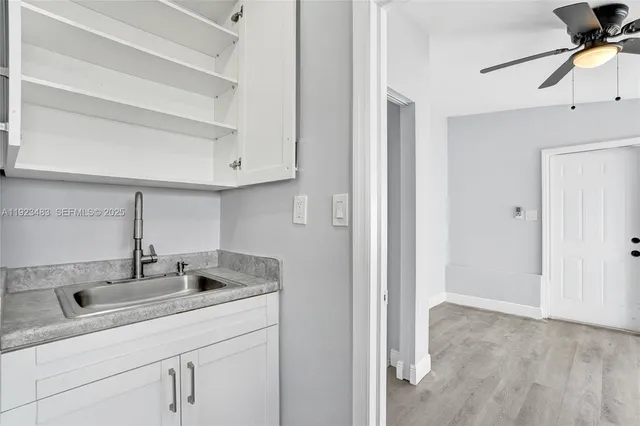 a kitchen with a sink and cabinets
