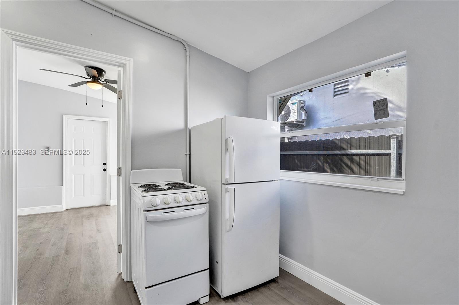 3633 Southwest 12th Court, Unit 1 Fort Lauderdale, FL 33312 - Photo 4 of 6 a kitchen with a refrigerator and a stove