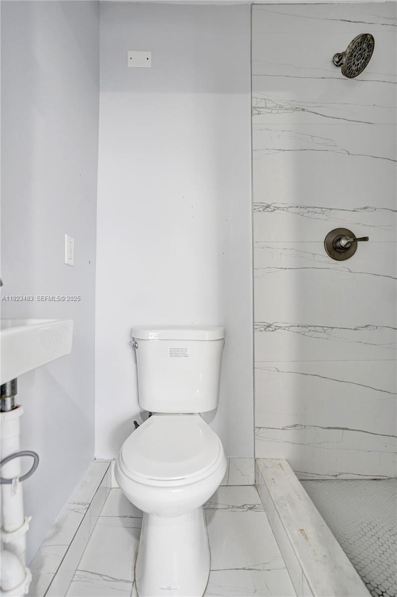 3633 Southwest 12th Court, Unit 1 Fort Lauderdale, FL 33312 - Photo 6 of 6 a bathroom with a toilet and a shower