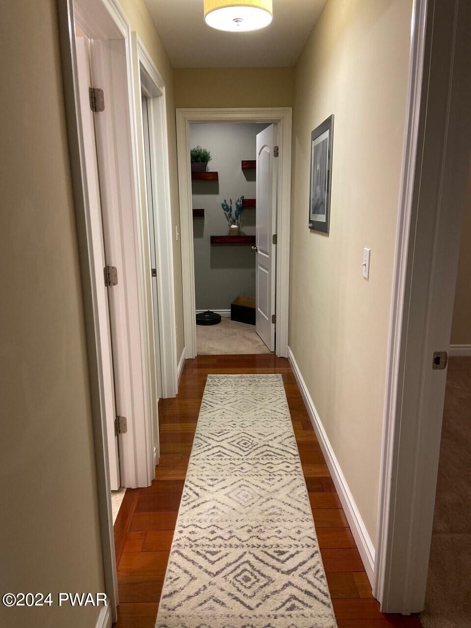 355 Summit Woods Road Moscow, PA 18444 - Photo 10 of 10 a view of a hallway with wooden floor and a living room