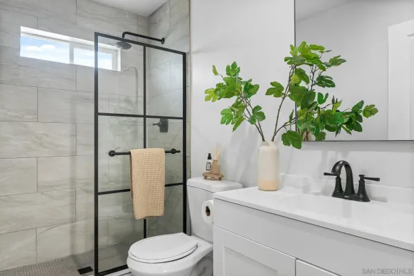 a bathroom with a sink a toilet and a mirror