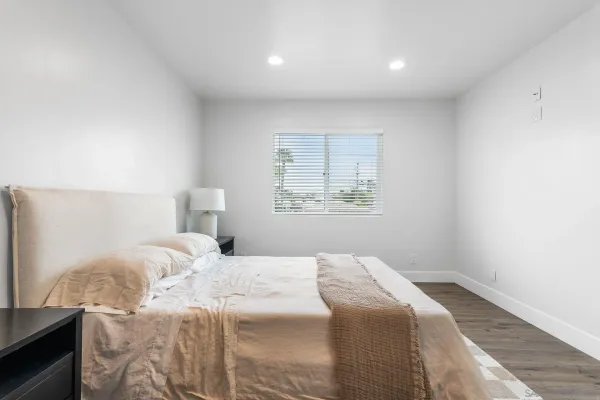 a bedroom with a bed and a window