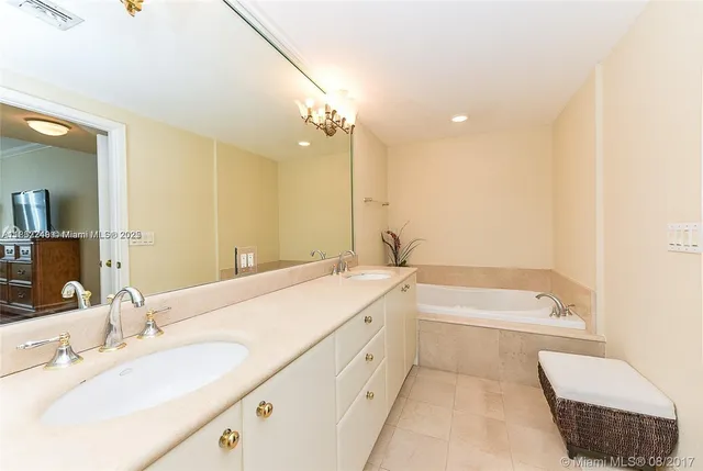 a bathroom with a tub a sink and a mirror