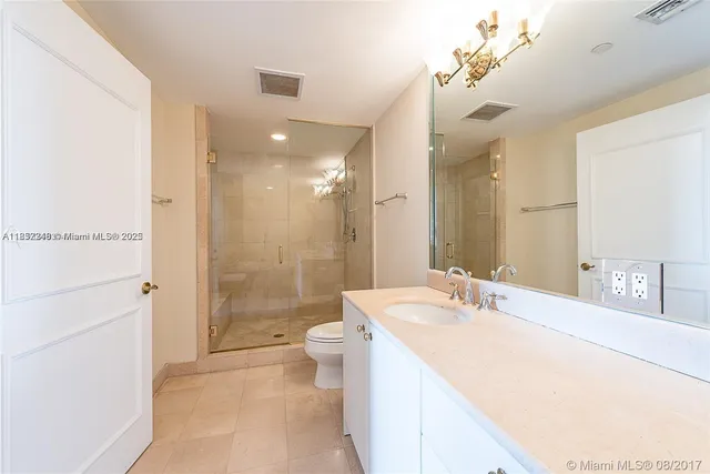a spacious bathroom with a bathtub shower sink mirror and toilet