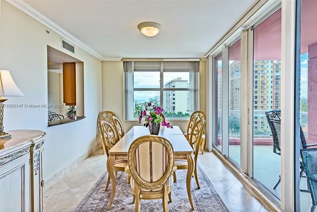 a dining room with furniture a chandelier and wooden floor