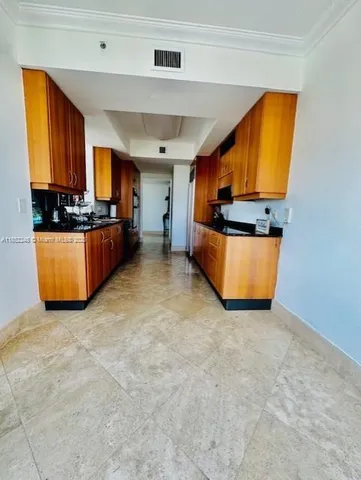 an empty room with a kitchen view