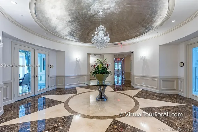 a dining room with wooden floor a chandelier a wooden table and chairs