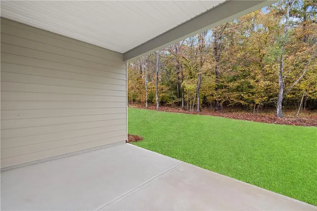 a backyard of a house with table and chairs
