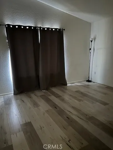 an empty room with wooden floor