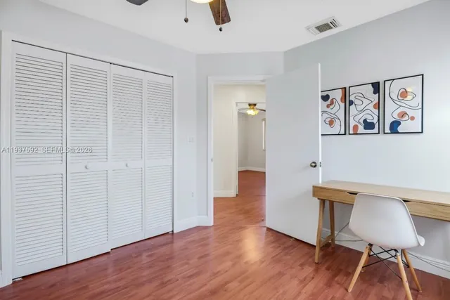 a view of a room with wooden floor and lounge chair