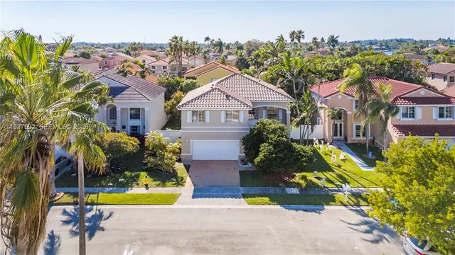 a view of a house with a swimming pool and sitting area
