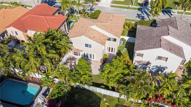 an aerial view of a house with a yard and garden