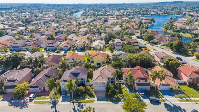 an aerial view of residential houses with outdoor space
