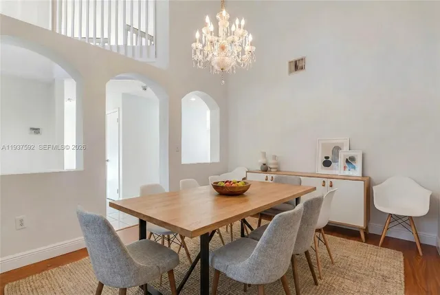 a view of a dining room with furniture and chandelier