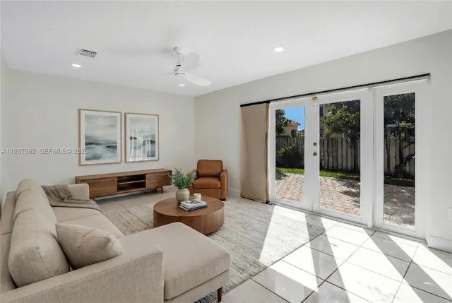 a living room with furniture and large window with garden view