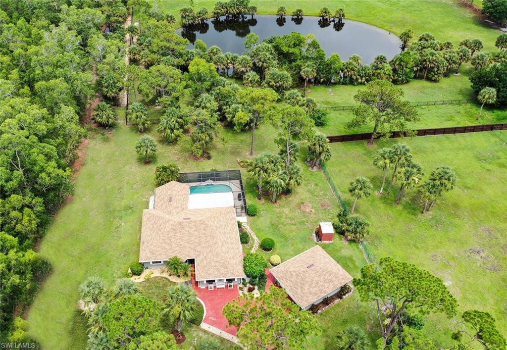 an aerial view of a house with a yard and lake view