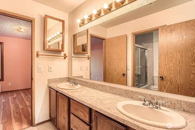 a bathroom with a granite countertop sink and a mirror