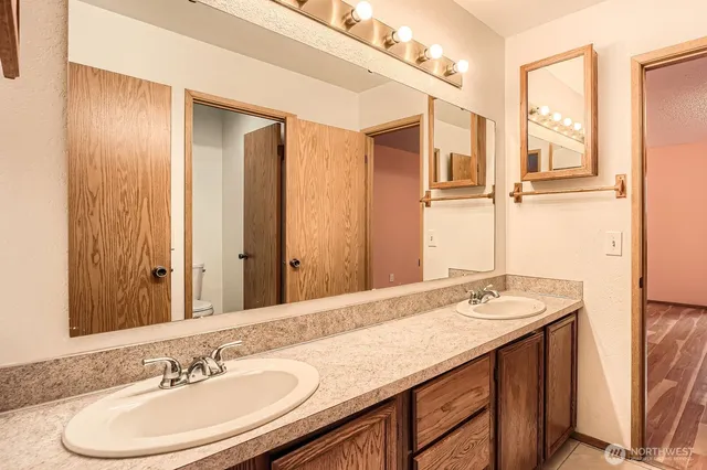 a bathroom with a sink double vanity and a mirror