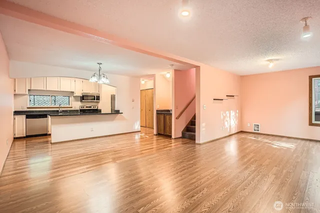 a view of a kitchen with a sink and a stove top oven