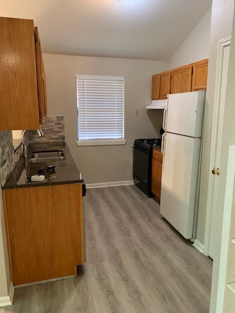 420 Nursery Road Spring, TX 77380 - Photo 9 of 26 a kitchen with a refrigerator and a stove